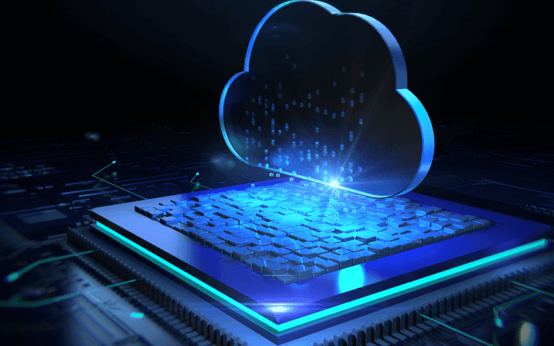 Futuristic image of a glowing blue cloud above a digital microchip, symbolizing cloud computing. The scene conveys innovation and digital connectivity.