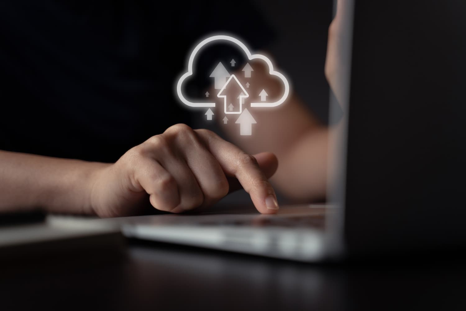 Close-up of hand interacting with digital cloud icon on device, representing our zero-cost data ingress transfer solutions.