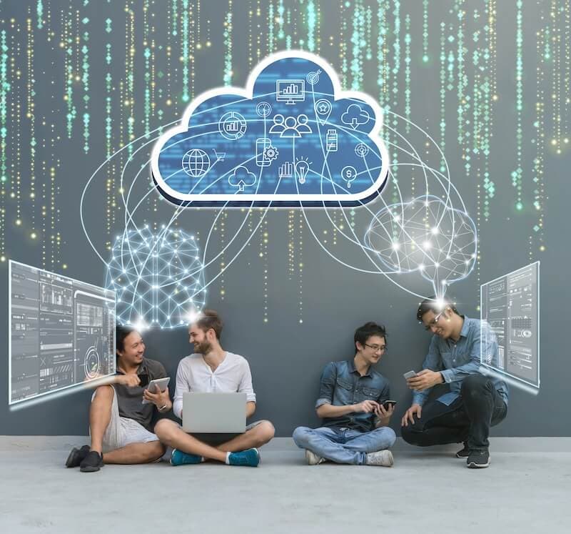 Four people sit casually, engaging with digital devices, beneath a digital cloud icon connected to virtual screens.