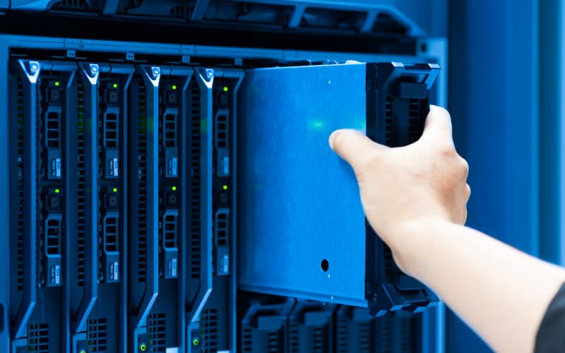 IT engineer repairing a server in a datacenter.