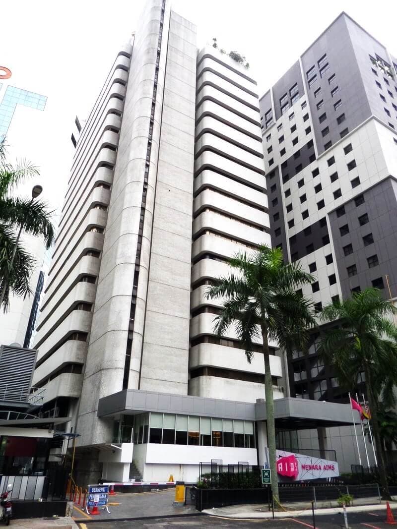 Enterprise-grade data center facility exterior housed in modern high-rise building with tropical landscaping