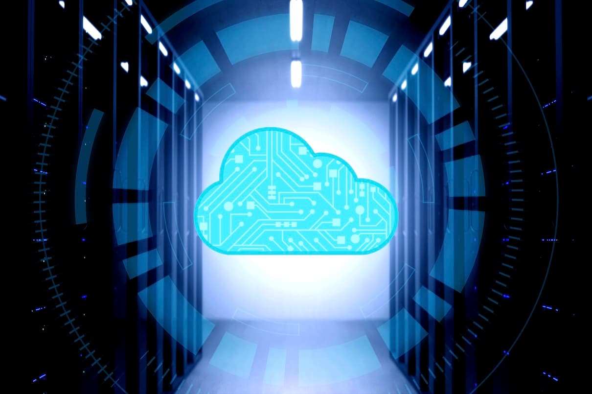 Futuristic server room with a glowing digital cloud icon in the center, symbolizing cloud computing and technological advancement.