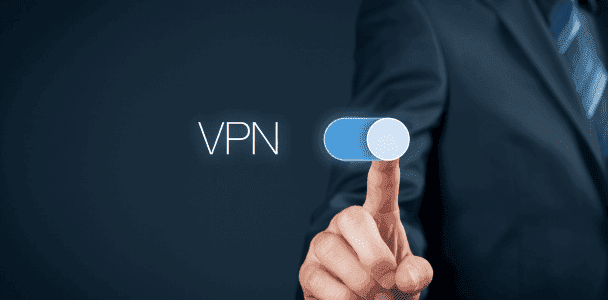 A person in a suit touches a digital toggle switch labeled 'VPN', set to 'on'. The image conveys a sense of security and technology.