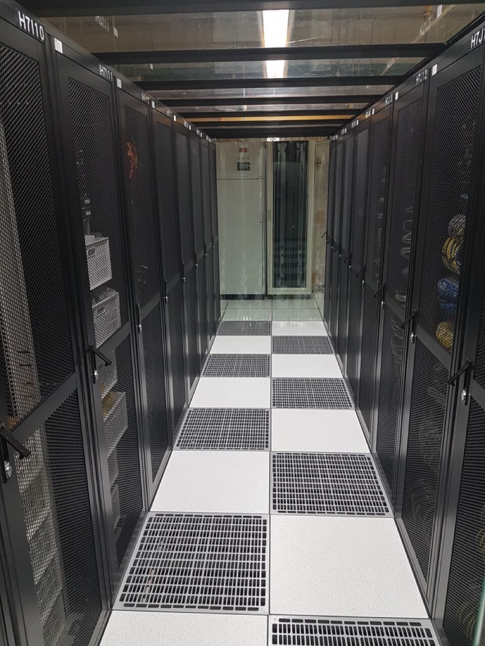 Interior hallway of a secure data center with server racks