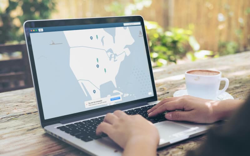 A person using a laptop with a map interface displaying a VPN connection, symbolizing secure remote access and proxy services.
