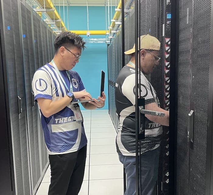 Technician controlling the server with a laptop. Technician controlling the server with a laptop.